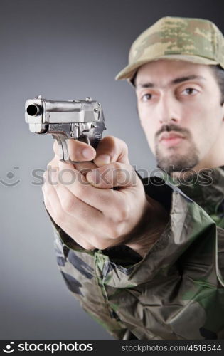 Soldier with gun in studio shooting