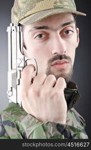 Soldier with gun in studio shooting