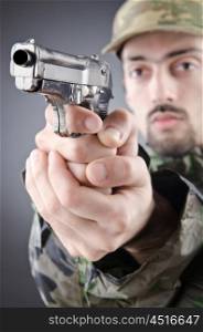 Soldier with gun in studio shooting