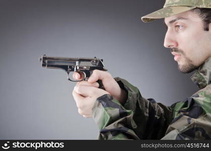 Soldier with gun in studio shooting