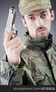 Soldier with gun in studio shooting