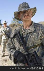 Soldiers in field, focus on soldier in foreground