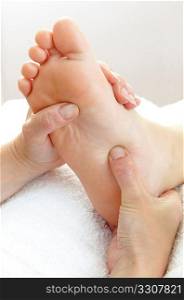 sole of a foot being massaged by pair of hands
