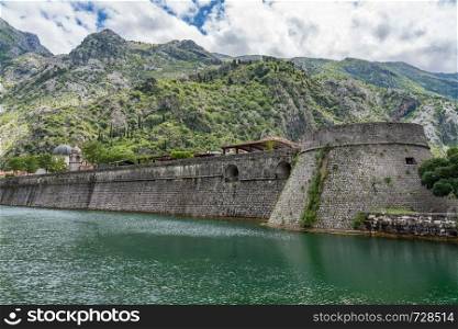 Solid stone walls surround the old town Kotor in Montenegro. Town walls surround the Old Town of Kotor in Montenegro