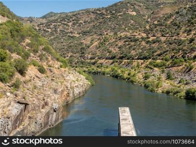 Solid structure of the Valeira dam on River Douro looking down into the gorge and narrow canyon. Leaving the lock of the Barragem da Valeira dam on the Douro river