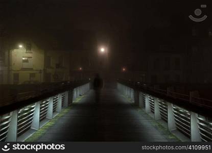 Solitary figure on Shandon bridge in Cork by night, Ireland