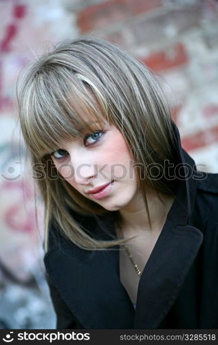 solitude - cute blonde girl against obsolete brick wall background