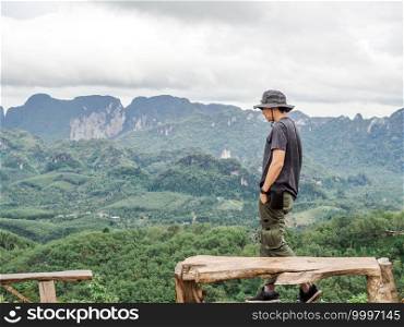 Solo traveller enjoying beautiful nature of hills and during rainy season at Doi Tapang, Sawi District, Chumphon, Thailand.