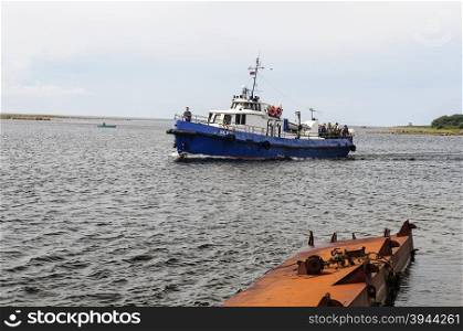 SOLOVKI, RUSSIA - JULY 19 2015, Marine boat with tourist group coming to the shore of the Big Solovetsky Island on July 19, 2015.