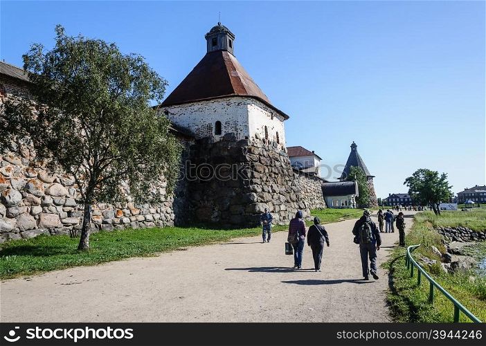 SOLOVKI, RUSSIA - JULY 21 2015, Tourists walk near the walls of Solovetsky monastery on July 21, 2015.