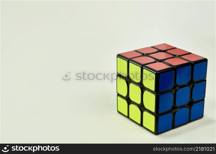 solved rubik&rsquo;s cube in blue, yellow and orange on white background.. solved rubik&rsquo;s cube in blue, yellow and orange on white background