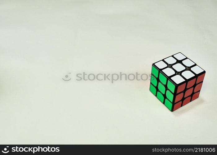 solved rubik&rsquo;s cube in white, green and red on white background with copy space.. solved rubik&rsquo;s cube in white, green and red on white background with copy space