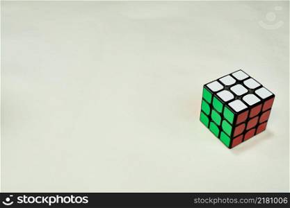 solved rubik&rsquo;s cube in white, green and red on white background with copy space.. solved rubik&rsquo;s cube in white, green and red on white background with copy space