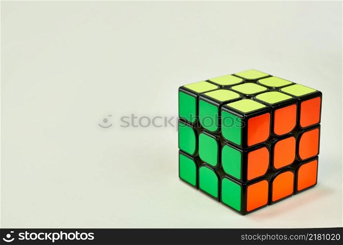 solved rubik&rsquo;s cube in yellow, green and orange on white background 2.. solved rubik&rsquo;s cube in yellow, green and orange on white background 2