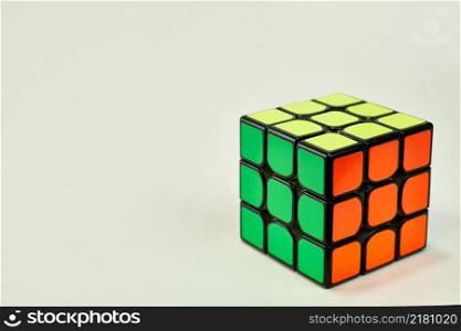 solved rubik&rsquo;s cube in yellow, green and orange on white background 2.. solved rubik&rsquo;s cube in yellow, green and orange on white background 2