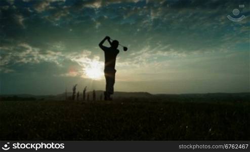 solw motion golf drive. sunset, backlight shot