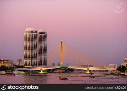 Somdet Phra Pinklao Bridge over the Chao Phraya River at sunset in Bangkok, Thailand