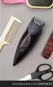 Some barber&acute;s accessories over gray background