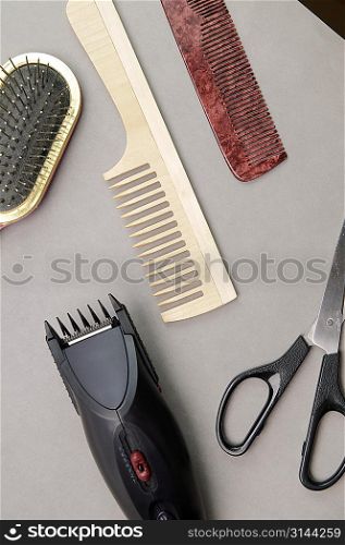 Some barber&acute;s accessories over gray background