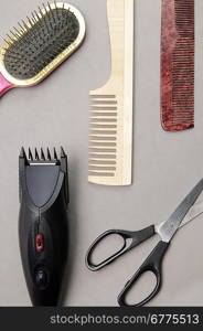 Some barber&acute;s accessories over gray background