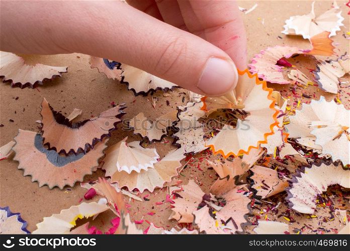 Some colorful pencil shavings in hand