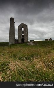 Some derelict buildings, including a chimney at a disused mine, Magpie Mine, in the Peak District