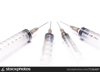 some disposable syringes on a white background