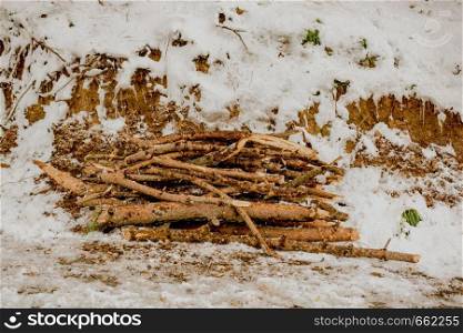 Some fire wood in a winter background in white color