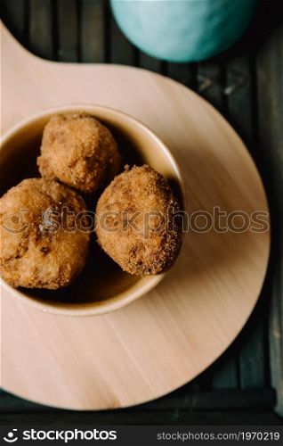 Some fried meatballs over a wooden table on the kitchen