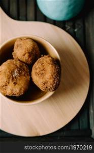 Some fried meatballs over a wooden table on the kitchen