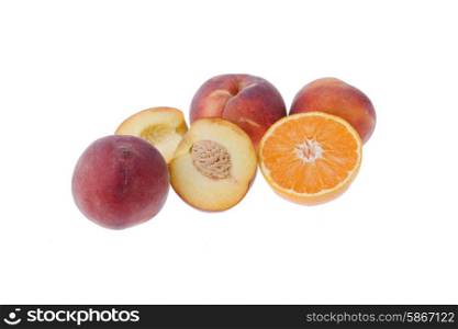 some peaches and a orange isolated on white background