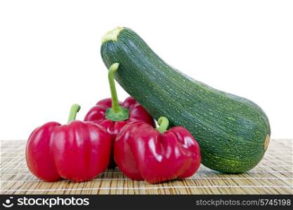 some peppers and a zucchini, isolated on white background