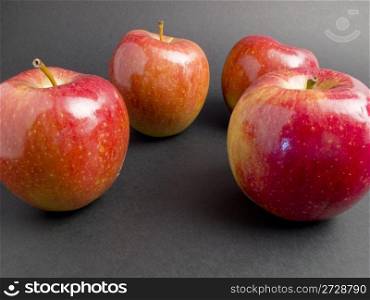 Some red apples and fresh on a black background
