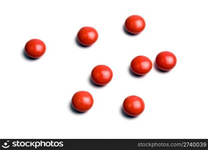 Some red pills isolated on white background