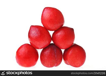 some red plums isolated on white