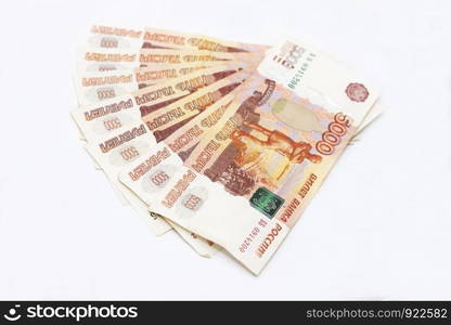 Some scattered Russian 5000 rubles banknotes closeup isolated on the white background