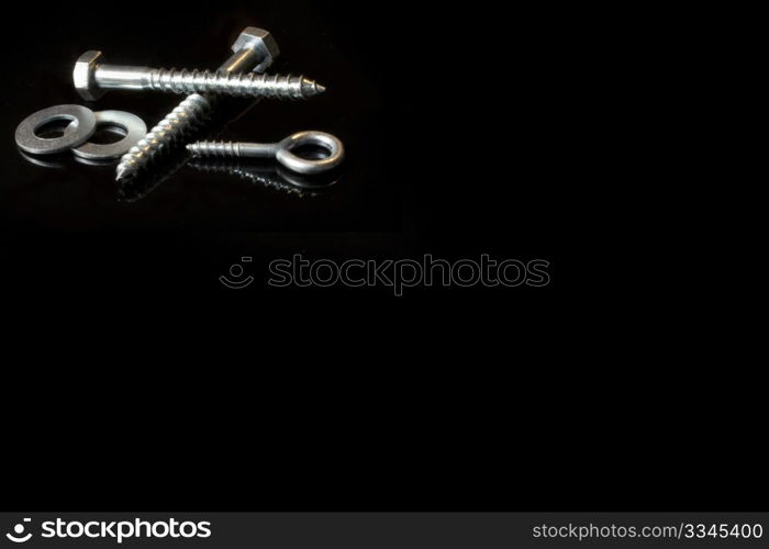 some screws and cross on a black background