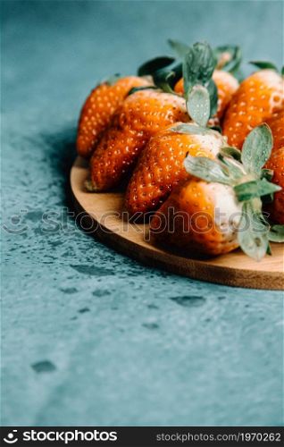 Some strawberries over a wooden plank with delicious aspect