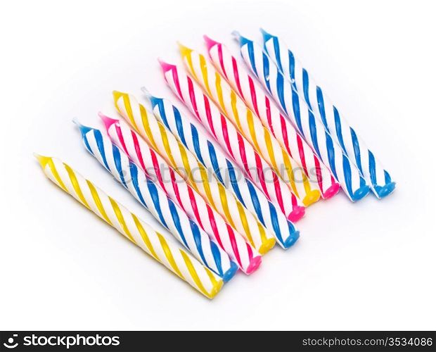 some striped birthday candles on white background