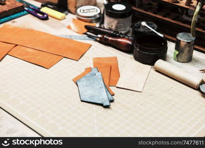 Some tools and materials for work with leather over table background. Some tools for work with leather