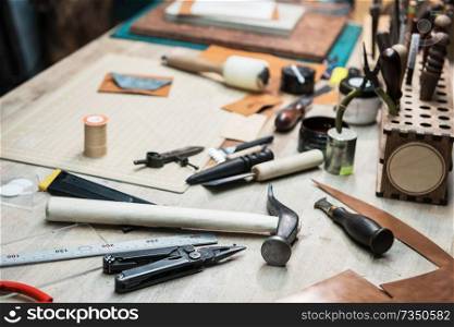 Some tools for work with leather over table background. Some tools for work with leather