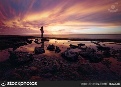 Somebody enjoying the sunset on rocky coast at San Ignacio Lagoon, Baja California, Mexico