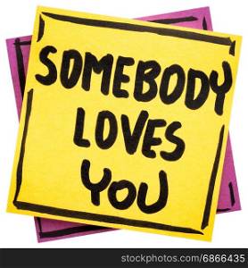 Somebody loves you reminder - handwriting in black ink on an isolated sticky note