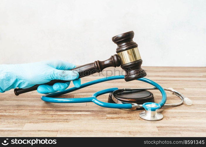 someones hand with law gavel in hand, medical law concept. medical law concept