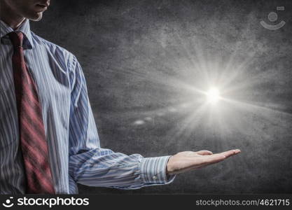 Something magic. Close up of male hand and light glowing in his palm