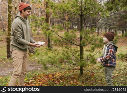 son father playing outdoors nature together