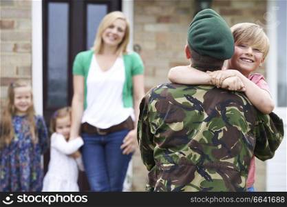 Son Greeting Military Father On Leave At Home