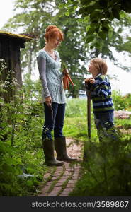 Son Helping Mother in Garden