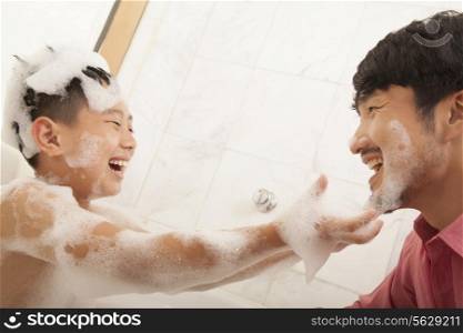 Son in Bathtub puts Soap on His Father&rsquo;s Face