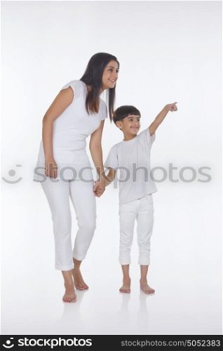 Son pointing as mother looks on